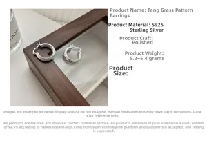 Macro detail of S925 sterling silver hoop earrings with vintage vine pattern engravings