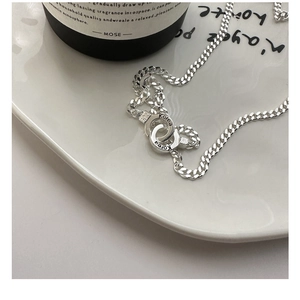 Detail of S925 silver Cuban link necklace featuring interlocking double rings with engraving