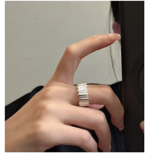 Detail of S925 sterling silver ring with vertical ridges and textured geometric wide band
