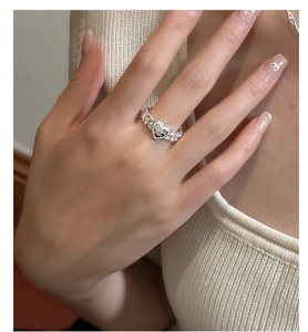 Macro detail of S925 silver heart ring featuring thick chain band and engraved lettering