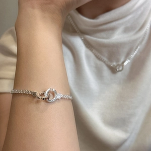 S925 sterling silver cuban chain bracelet with horseshoe clasp worn on a wrist