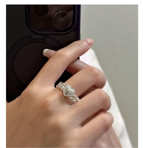 Macro detail of silver S925 heart ring with Cuban link chain and FOR LOVE engraving