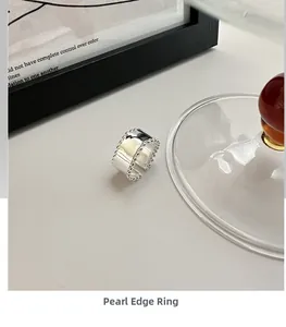 Macro detail of S925 sterling silver beaded edge ring with polished finish and open design