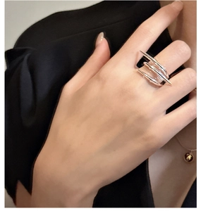 Detail of 925 sterling silver multi-layer crossover ring with sharp punk thorn design