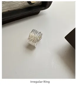 Macro detail of S925 sterling silver irregular ring with vintage engraved patterns
