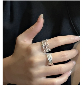 Macro shot of 925 sterling silver layered rings with Chaine d'Ancre design elements