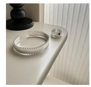 Detail of S925 sterling silver stamp and beaded edges on minimalist ring and cuff