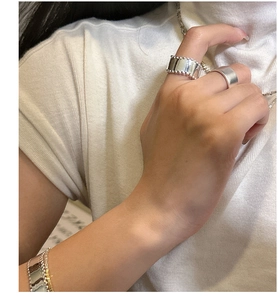 Detail of S925 sterling silver wide rings and matching bracelet with bead edge texture