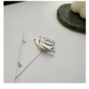 Detailed view of 925 sterling silver triple layered cross ring on a minimalist stone