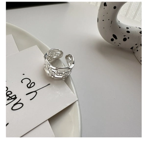 Detailed view of triple-layered S925 sterling silver anchor link ring on a tray