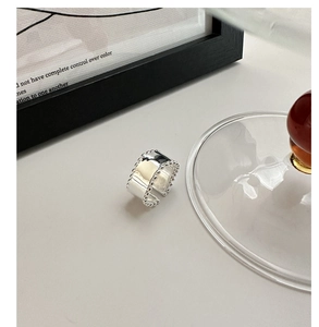 Detail of S925 sterling silver wide open ring with polished finish and beaded edge