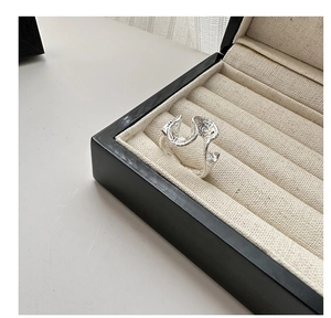 Detailed view of S925 sterling silver ring with liquid lava texture in a jewelry box