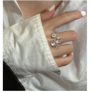 Detail of S925 sterling silver ring with wavy texture and minimalist hammered finish