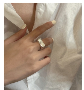 Détail d'une bague carrée large en argent sterling S925 avec une finition miroir polie