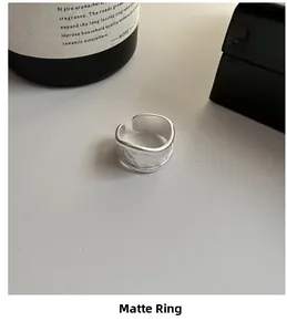 Close-up of matte S925 sterling silver wide ring with irregular edges and frosted finish