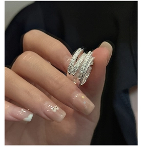 Detailed view of layered S925 sterling silver rings with micro-pave zirconia crystals