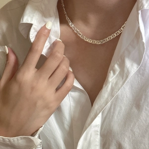 Collana a catena ancora minimalista in argento sterling S925 su una camicia di cotone