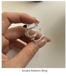 Close-up of S925 sterling silver snake ring with black zircon and detailed scale texture