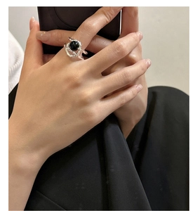 Macro view of S925 sterling silver ring with black onyx stone in fluid design