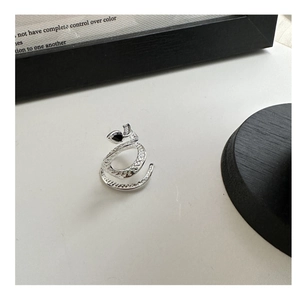 Close-up of S925 silver snake ring with textured scales and black teardrop zircon