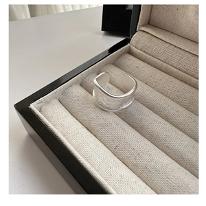 Close-up of wide S925 sterling silver ring with matte finish and irregular texture detail