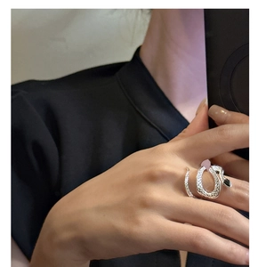 Close-up of S925 sterling silver snake ring with black zircon eyes on female finger