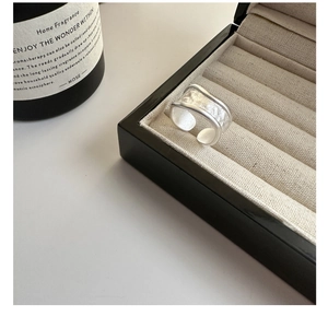 Detailed view of matte S925 sterling silver wide ring with hammer texture in jewelry box