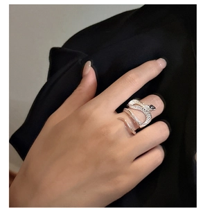 Detail of silver snake ring featuring black zircon eye and textured scale patterns