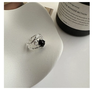 Detailed shot of S925 silver ring featuring liquid metal texture and black agate bead