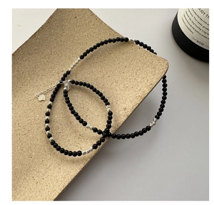 Detail of S925 sterling silver black onyx beaded necklace with heart charm and clasp