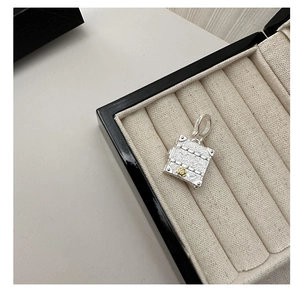 Close-up of S925 silver chest pendant with vintage floral carvings and gold flower accent