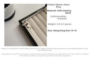 Detailed view of polished S925 sterling silver hammered heart ring in a jewelry box slot