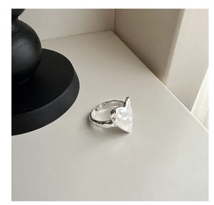 Macro detail of the hammered texture and S925 hallmark on the heart shaped silver ring