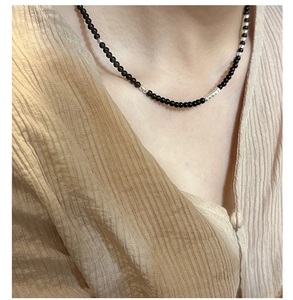 Detail of S925 sterling silver beaded necklace with black onyx and textured silver spacers