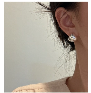 Polished S925 sterling silver water drop stud earring shown on a female model's ear