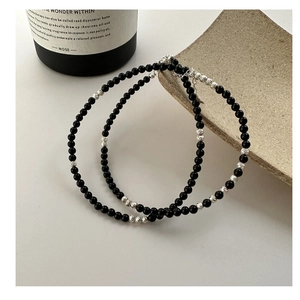 Detailed view of S925 silver necklace with black agate beads and spiral silver accents