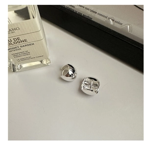 Macro detail of minimalist S925 sterling silver chunky hoop earrings with high-polish finish