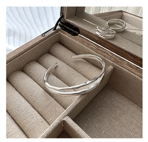 Detail view of 925 sterling silver layered texture cuff bracelet in a wooden jewelry box