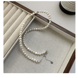 Close-up of irregular natural pearls and S925 sterling silver clasp on a jewelry tray