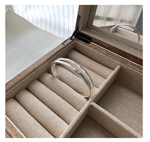 Detailed view of 925 sterling silver double-layer bracelet with hammered texture in jewelry box