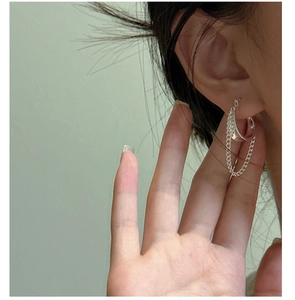 Close-up of minimalist S925 sterling silver hoop earrings with dangling chain tassels