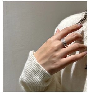 Close-up of minimalist double-layer silver ring with texture on female hand