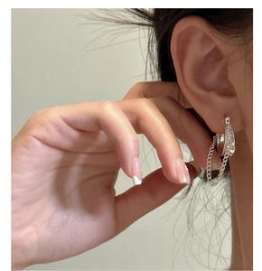 Close-up of minimalist S925 sterling silver hoop earrings with delicate tassel chains