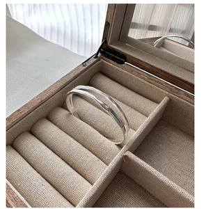 Detail of 925 silver double-layered ring with irregular hammered texture on jewelry box