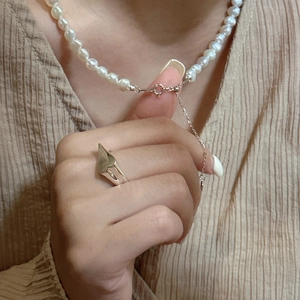 Minimalist S925 silver irregular pearl drawstring necklace worn on linen fabric