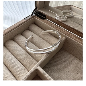 Detail of double-layered S925 sterling silver wavy texture cuff inside jewelry box