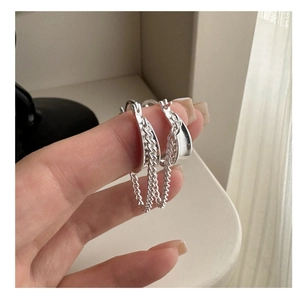 Detail view of S925 sterling silver hoop earrings with delicate hanging tassel chains