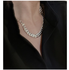 Gros plan d'un collier chaîne gourmette épaisse en argent sterling S925 sur un mannequin
