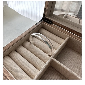Detailed view of 925 silver hammered texture double layer bracelet in a wooden jewelry box