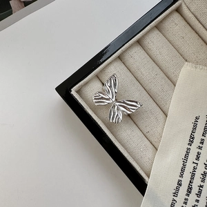 S925 sterling silver bow ring with textured wings in a beige jewelry gift box